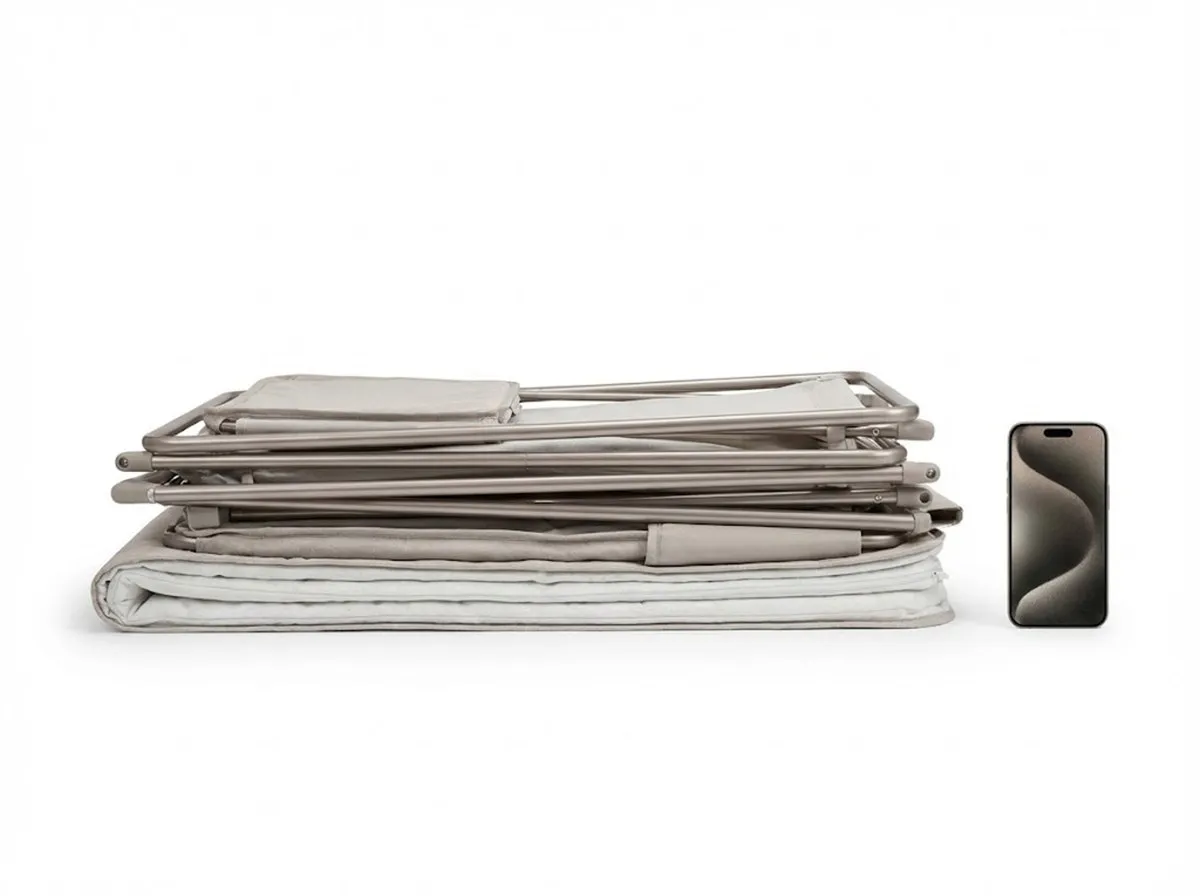 High-Loading Bassinet BD451 folded flat next to a smartphone to show ultra-compact packaging size.